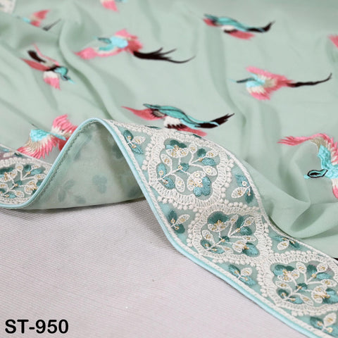 a close-up view of a fabric with a floral pattern, including pink and green birds. The fabric appears to be a light green color, and the pattern is intricate and detailed.