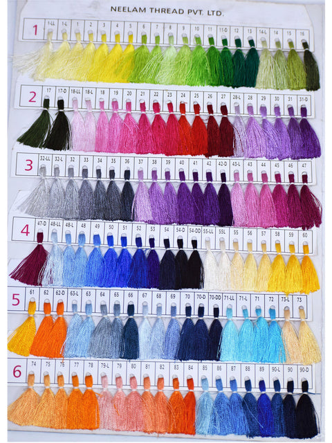 a collection of various colored thread tassles arranged in rows and columns, likely for a sewing or textile project.