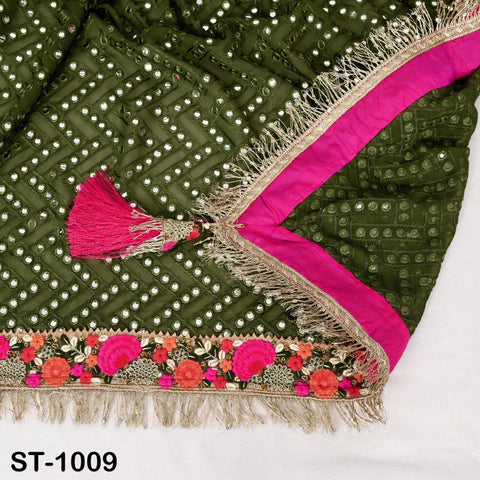 a close-up view of a decorative fabric with a green and pink color scheme, featuring a tassel and floral embellishments.