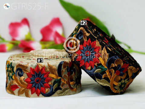 two decorative fabric pieces with intricate floral embroidery, placed on a white surface.