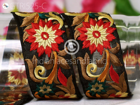 two decorative fabric pieces with intricate floral embroidery in red, yellow, and green colors.