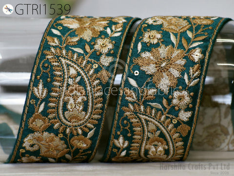 two ornate, intricately embroidered fabric pieces with a floral and paisley design in shades of green and gold.