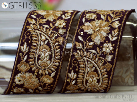 two ornate, decorative fabric pieces with intricate floral and paisley patterns in shades of purple and gold.