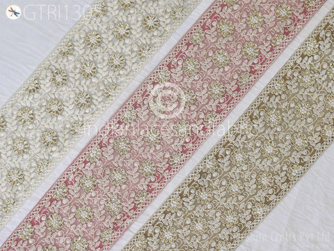 three decorative fabric strips with intricate floral patterns in various colors, including white, pink, and brown.