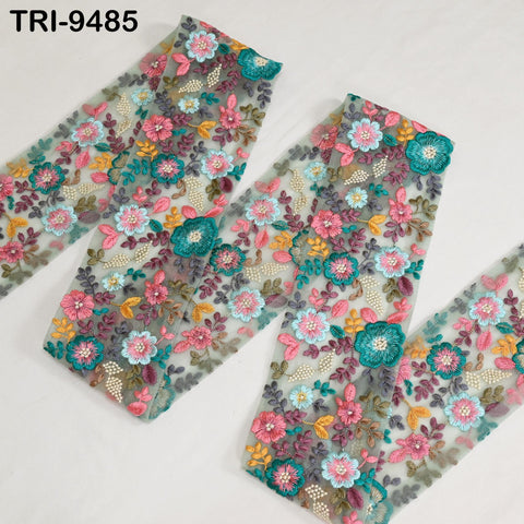 a pair of colorful, floral-patterned fabric pieces, possibly a scarf or a garment, with a variety of pink, green, and blue flowers and leaves.
