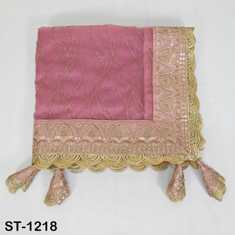 A pink and gold embroidered fabric with a scalloped edge and tassels at the bottom.