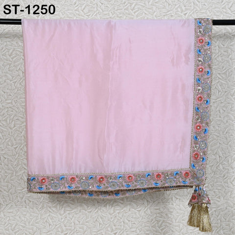 A pink satin garment with a decorative border and tassel hanging from the bottom.