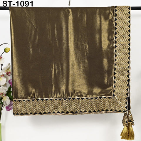 a brown satin fabric with a gold and black zigzag pattern trim, hanging on a hanger.