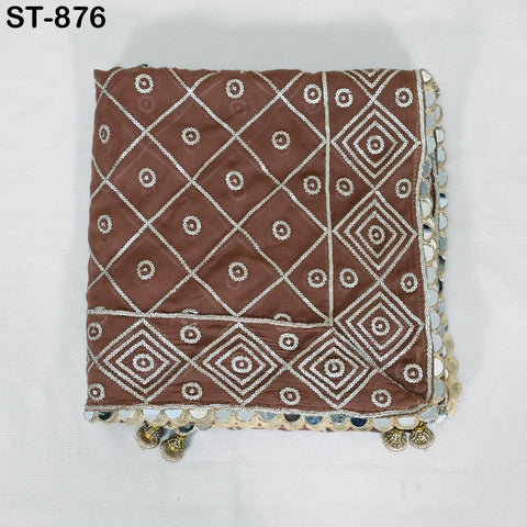 a brown fabric with a diamond pattern and small white circles, possibly a decorative piece or a textile.