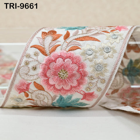 a close-up view of a decorative fabric with a floral pattern, including pink and white flowers, as well as other colorful floral elements.