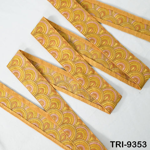 a set of decorative fabric ribbons with a repeating pattern of yellow and orange circles on a white background.