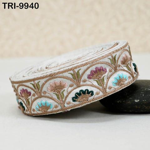 A decorative fabric with a floral pattern, featuring a variety of colors including pink, blue, green, and brown.