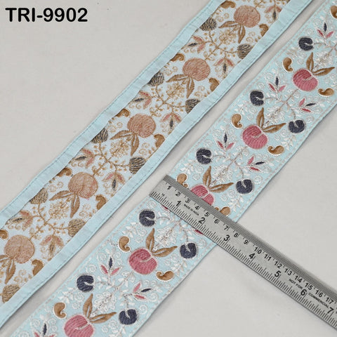 a close-up view of a decorative fabric with a floral pattern, featuring a ruler placed on top of it.