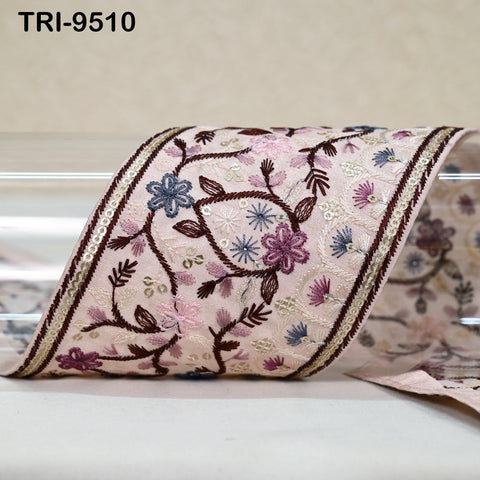 a decorative fabric with a floral pattern, featuring a variety of colors and intricate embroidery.