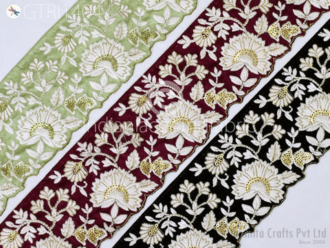 three different fabric pieces with intricate floral embroidery in various colors and patterns, including green, burgundy, and black.