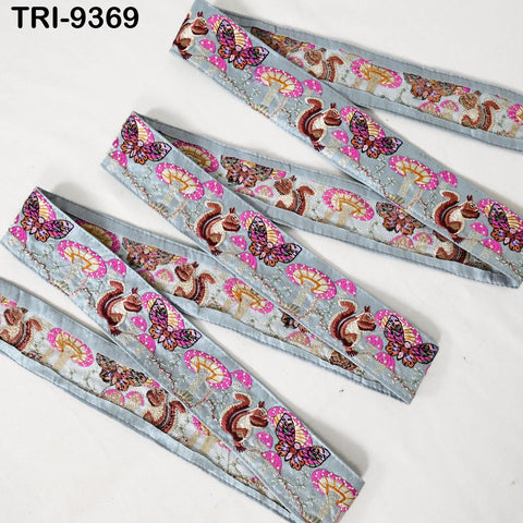 a collection of decorative fabric pieces with a repeating pattern of butterflies and other floral designs in shades of pink, blue, and green. The pieces appear to be made of a material that resembles fabric or ribbon, and they are arranged in a row on a white background.