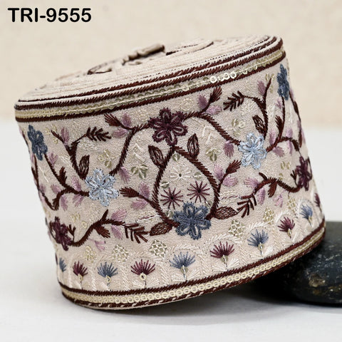 a decorative object with a floral pattern, including various shades of purple, blue, and white flowers and leaves. The object appears to be a piece of fabric or a decorative item with a floral design.