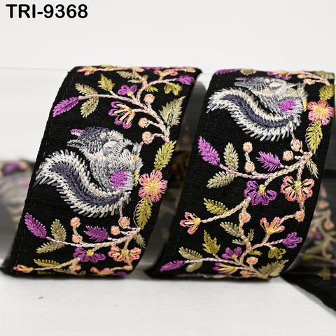 two decorative fabric pieces with intricate floral embroidery in black, purple, and yellow colors.