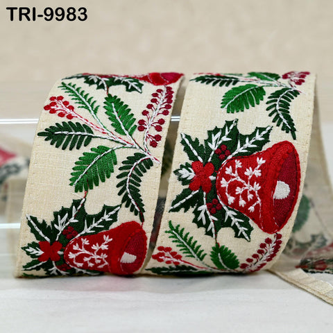 A close-up image of a decorative Christmas ribbon with a floral pattern in red, green, and white colors.