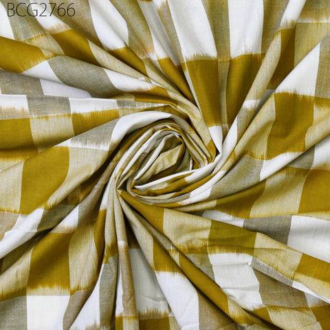 a close-up view of a fabric with a checkered pattern in shades of yellow and white. The fabric appears to be made of a woven material, with a spiral or twisted shape.