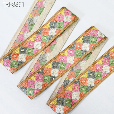 a collection of decorative fabric pieces with a floral pattern, including a border with a colorful, embroidered design.