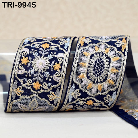 two pieces of fabric with intricate embroidered designs in shades of blue and gold.