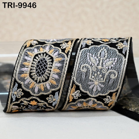 two decorative fabric pieces with intricate embroidered patterns in black, white, and gold colors.