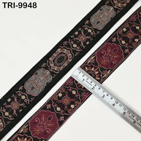 a decorative fabric with a floral pattern, and a ruler is placed on top of it to measure the length of the fabric.
