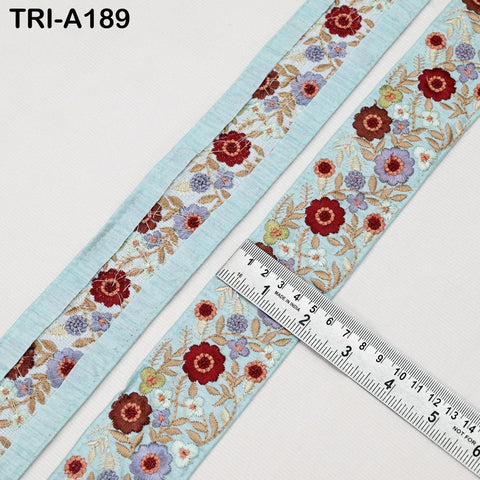 a close-up view of a decorative fabric with a floral pattern, featuring a ruler for scale.