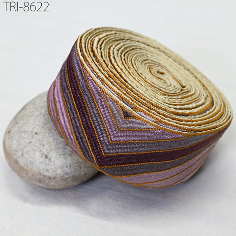 a close-up view of a decorative fabric with a striped pattern, resting on a white surface.
