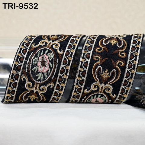 two decorative fabric pieces with intricate floral and ornamental patterns in black and gold colors.
