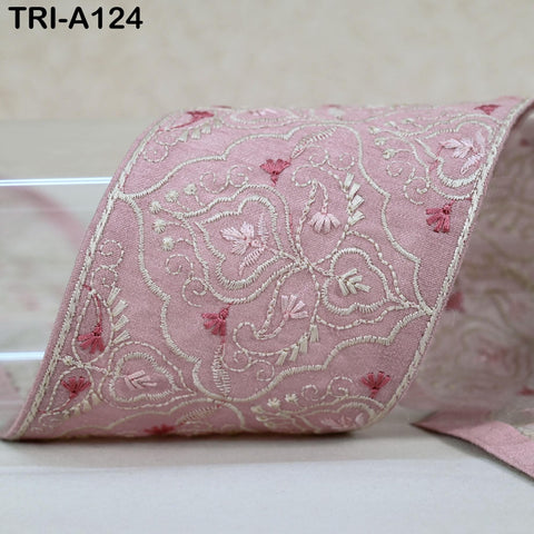 a close-up view of a decorative fabric with a floral pattern in shades of pink and white.