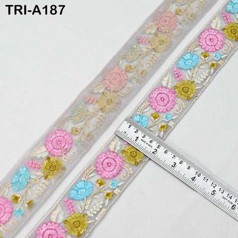 a decorative fabric with a floral pattern, featuring a ruler for size reference.