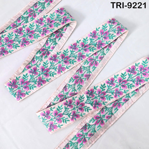 three pieces of fabric with a floral pattern in shades of pink and green. The fabric appears to be made of a soft, light-colored material, possibly silk or chiffon. The pattern consists of green leaves and pink flowers, creating a visually appealing and delicate design.