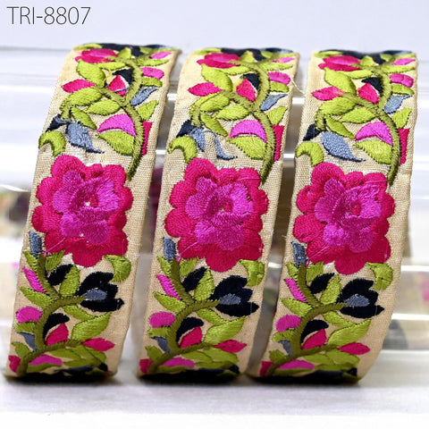 three decorative fabric pieces with floral patterns in shades of pink, green, and black.
