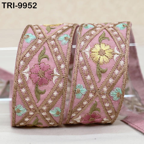 two decorative fabric pieces with intricate embroidered patterns in shades of pink, green, and yellow. The patterns include flowers and leaves, creating a visually appealing and detailed design.