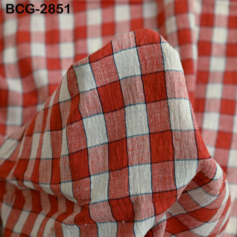 a close-up view of a fabric with a red and white checkered pattern.