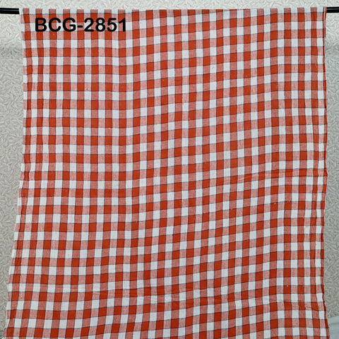 a red and white checkered fabric hanging on a metal bar.