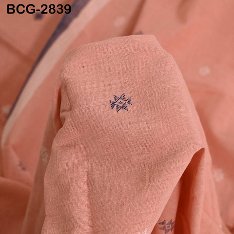 a close-up view of a fabric with a small blue embroidered design on it.