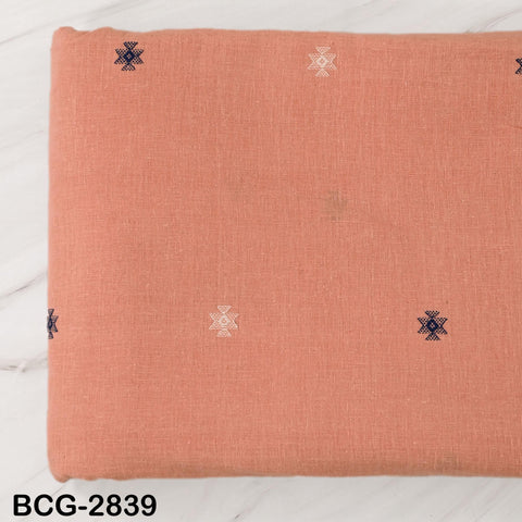 a piece of fabric with a pattern of small white stars and blue geometric shapes on it, placed on a white surface.
