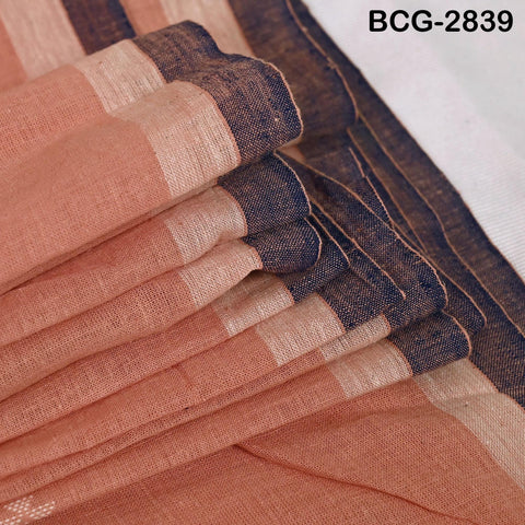 A close-up view of a folded fabric with a striped pattern in shades of orange and brown.