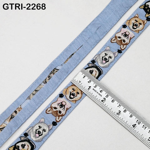 a blue fabric with a repeating pattern of dog faces, and a ruler is placed on top of the fabric to measure its length.