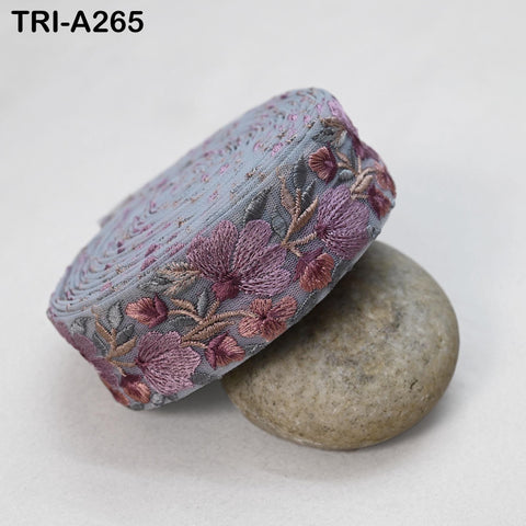 a decorative fabric with a floral pattern, resting on a rock.