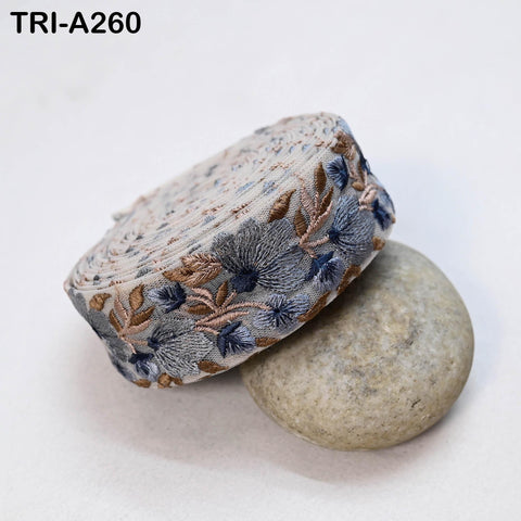 a decorative fabric with a floral pattern, placed on top of a rock.