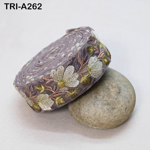 a decorative fabric with a floral pattern, resting on a rock.