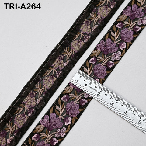 a close-up view of a decorative fabric with a floral pattern, featuring a ruler for size reference.