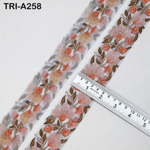 two pieces of fabric with a floral pattern, and a ruler is placed between them, indicating the size of the fabric.
