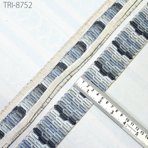 a close-up view of a piece of fabric with a metallic ruler placed on top of it, indicating the size or dimensions of the fabric.