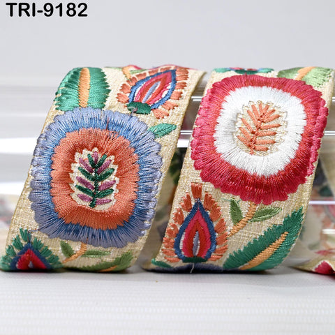 two decorative fabric pieces with intricate embroidered designs, including flowers and leaves in various colors.