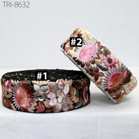 two decorative fabric items with floral patterns. The item on the left has a black background and the item on the right has a white background. Both items have a floral design with pink and red flowers.